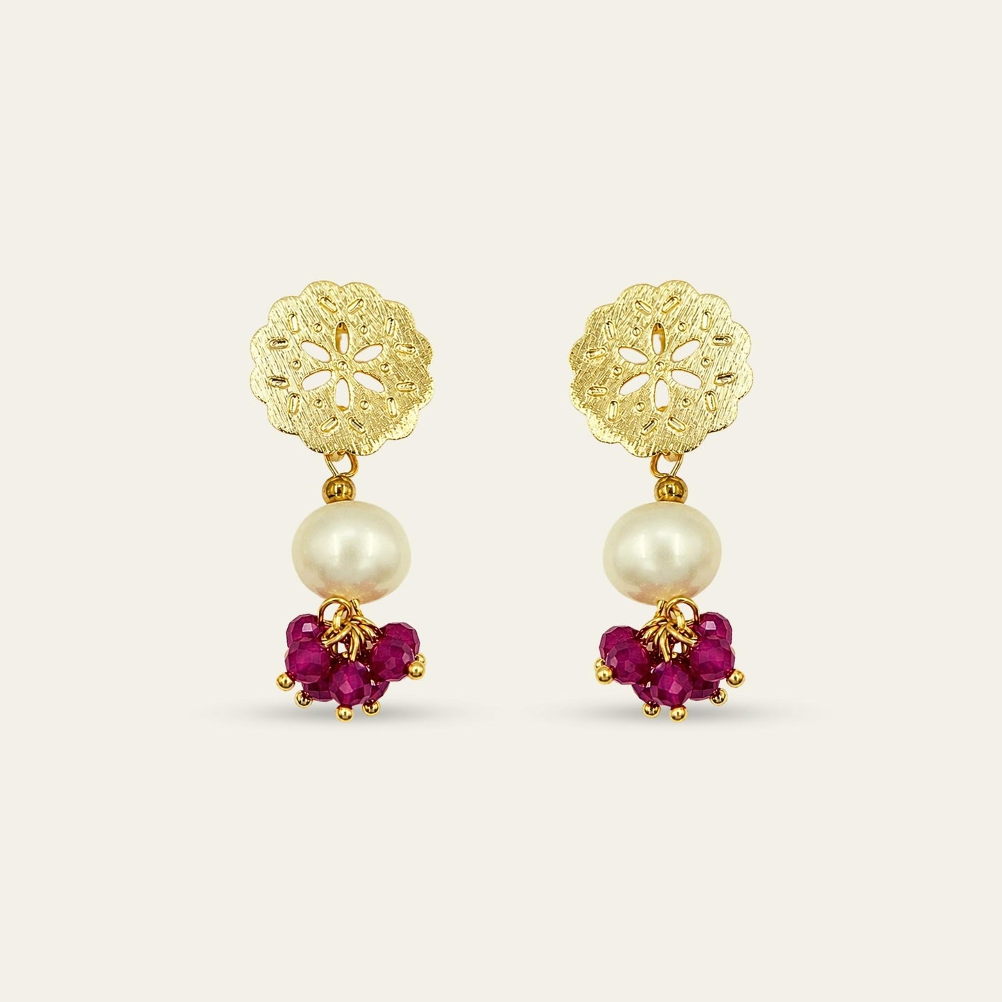 Aros con base de flor enchapada en oro 18k , perla de rio y piedras de color rojo granate,  sobre fondo blanco - Coca Johnson Joyas - Chile