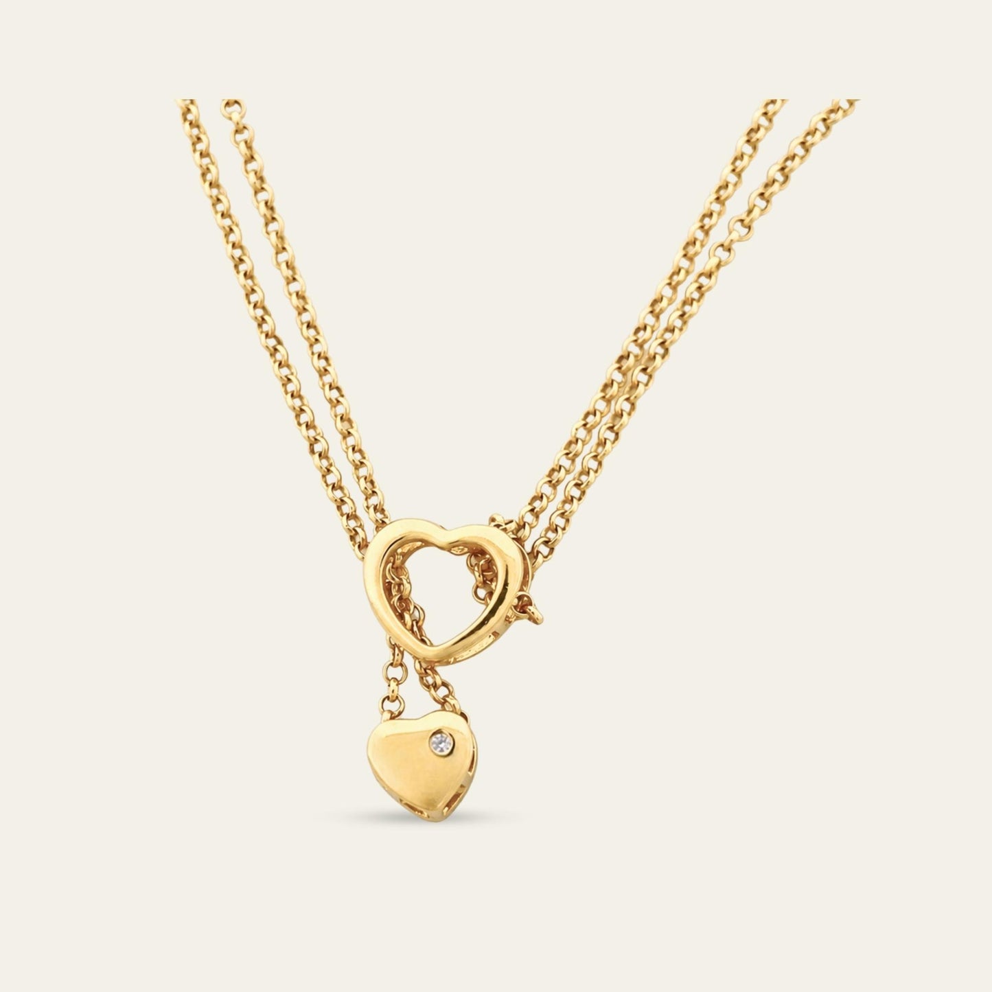 Collar exclusivo de doble cadena con corazones móviles y circones, enchapado oro 18kt, zoom a la parte de atras del corazon inferior. - Coca Johnson Joyas - Chile