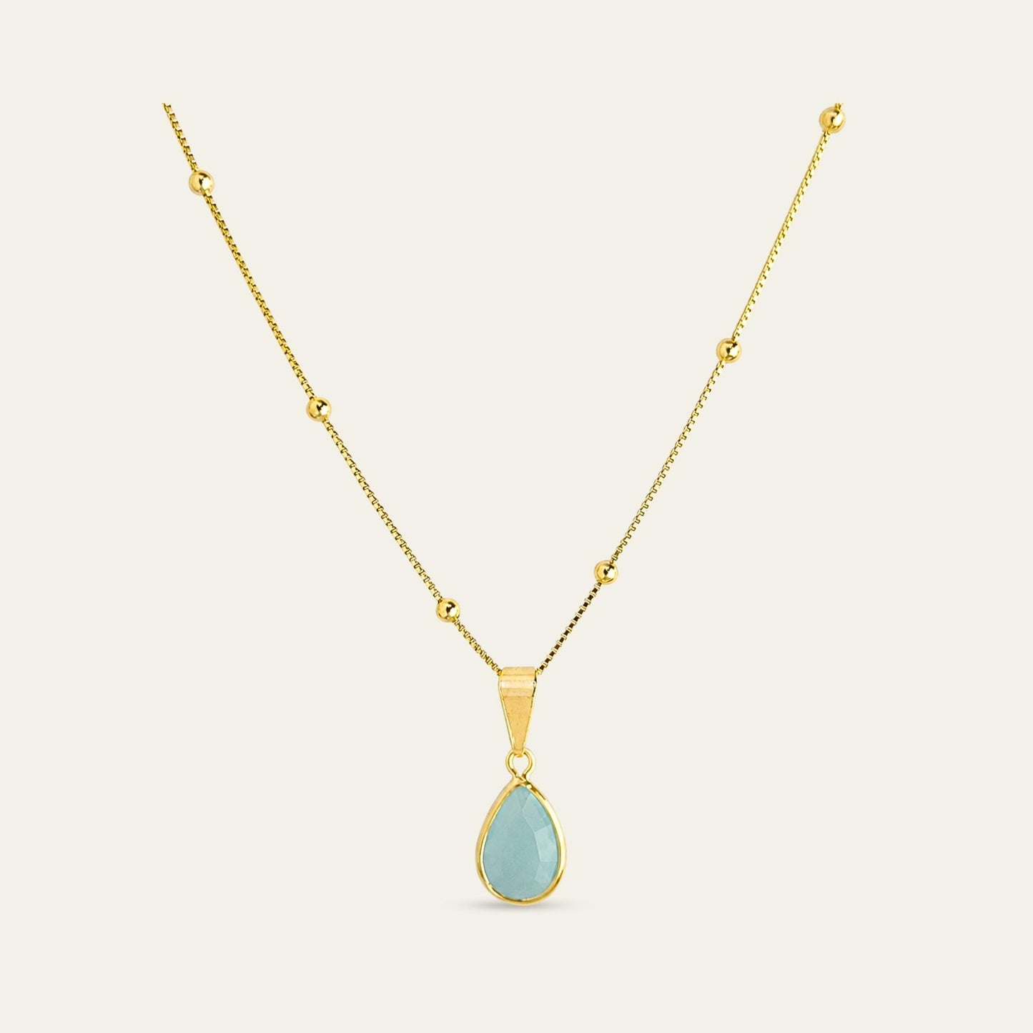 Collar_cadena enchapada en oro 18 Kt, colagante de gota color agua marina, sobre fondo blanco - Coca Johnson Joyas - Chile