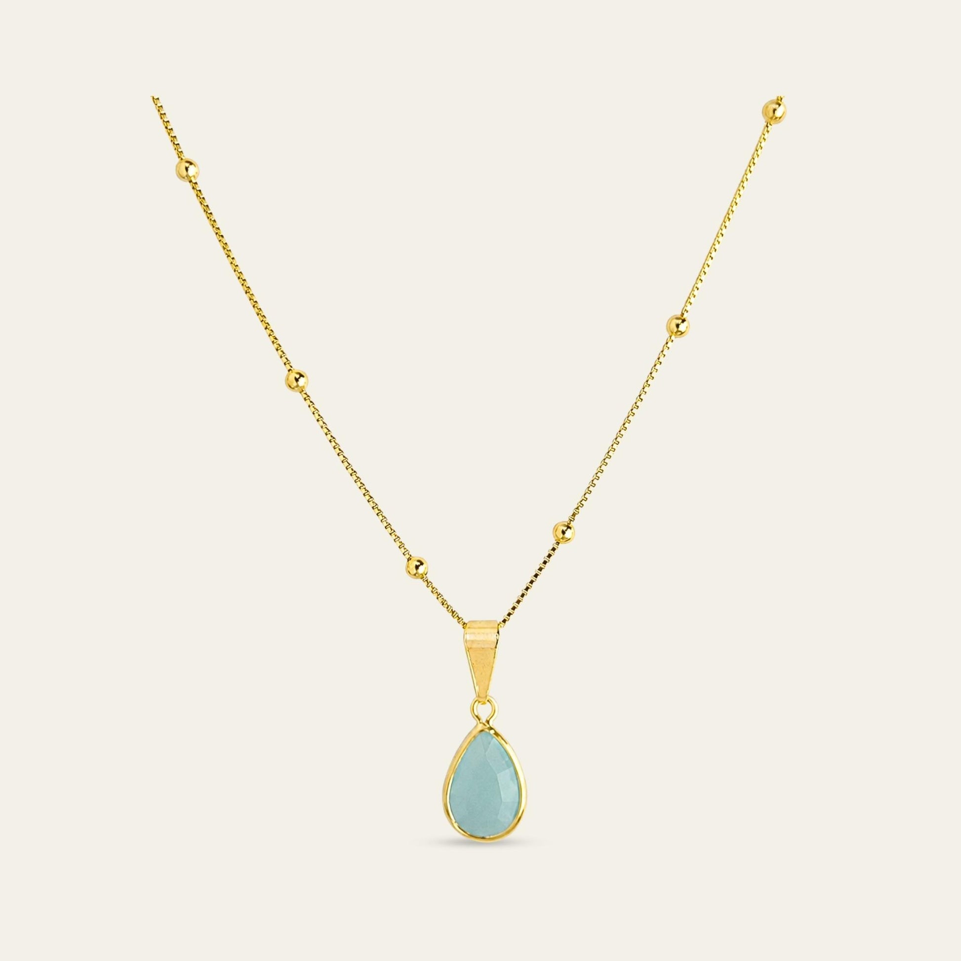 Collar_cadena enchapada en oro 18 Kt, colagante de gota color agua marina, sobre fondo blanco - Coca Johnson Joyas - Chile