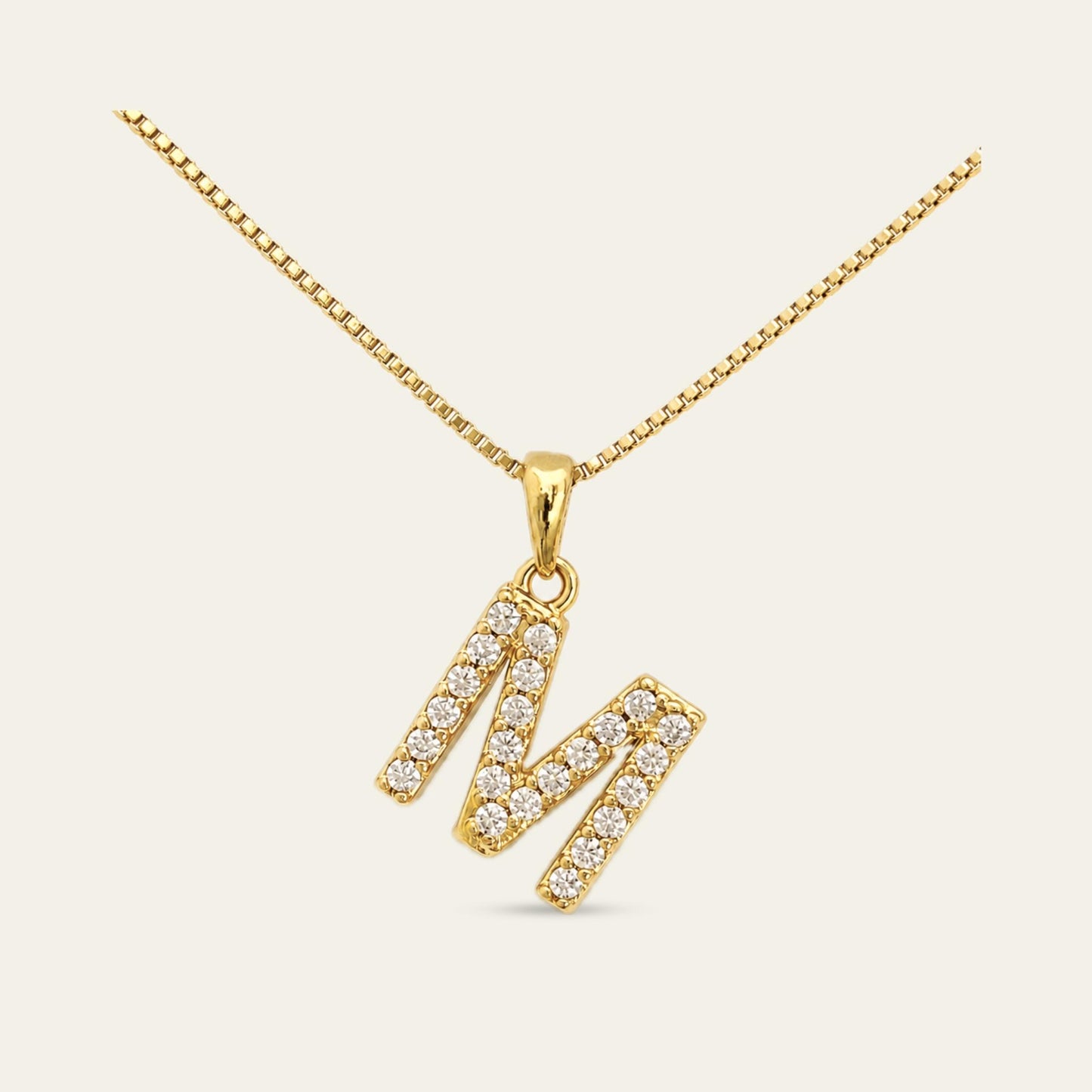 Colgante de letra inicial M enchapado en oro con circones 