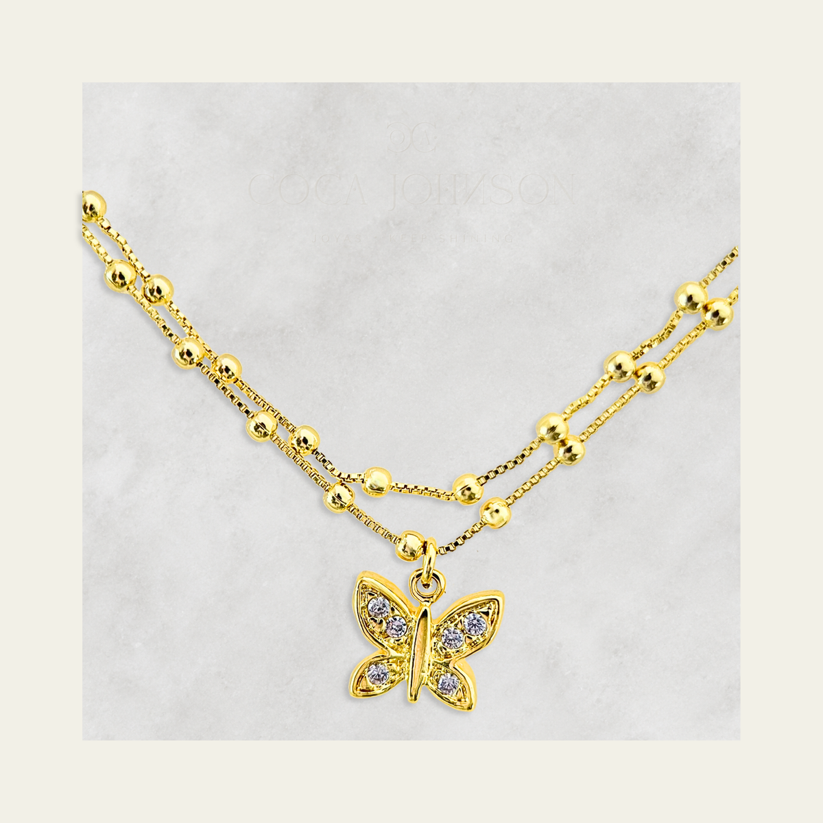 Zoom a pulsera doble con colgante de mariposa con circones